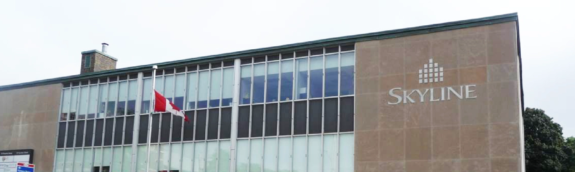 Exterior of an office building with glass windows.